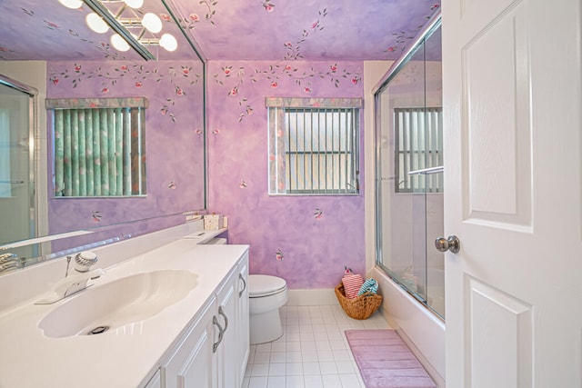 full bathroom with vanity, toilet, tile patterned floors, and shower / bath combination with glass door