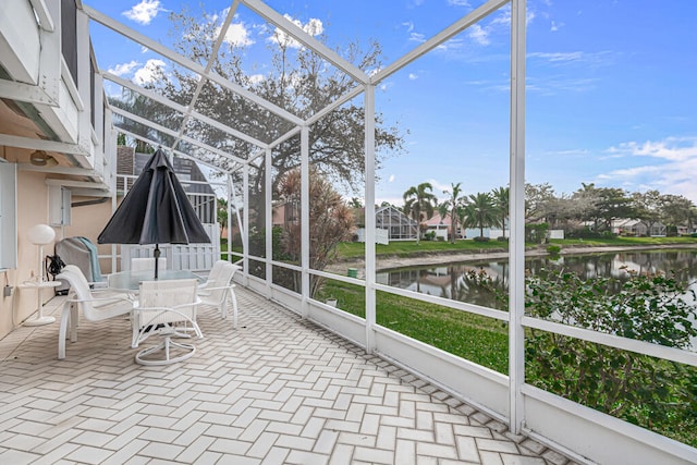 unfurnished sunroom with a water view