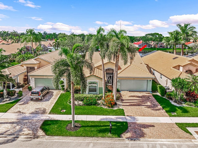 view of front of property with a front lawn and a garage