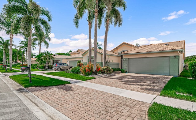 mediterranean / spanish-style house with a front yard and a garage