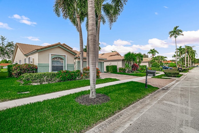 view of front of house with a front lawn and a garage