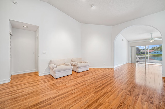 unfurnished room with vaulted ceiling, light wood-type flooring, and ceiling fan