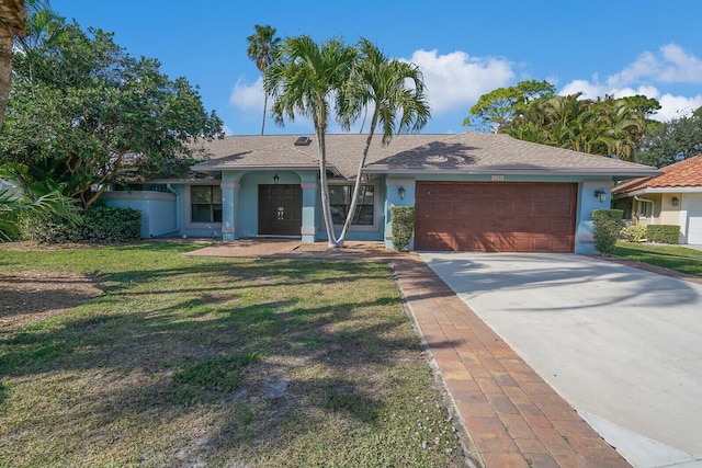 ranch-style home with a garage and a front lawn