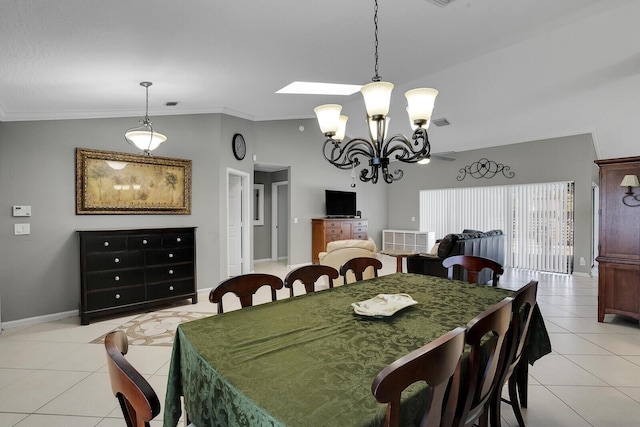 tiled dining area with vaulted ceiling, ornamental molding, and a chandelier