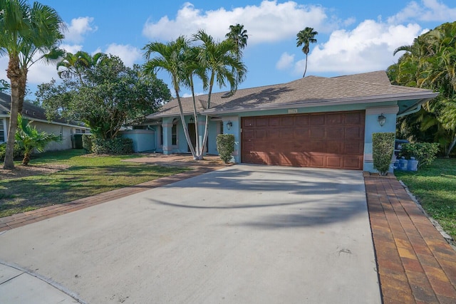 single story home with a garage and a front yard