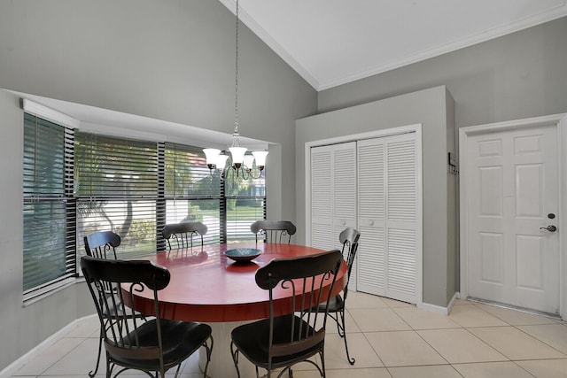 tiled dining space featuring crown molding, high vaulted ceiling, and an inviting chandelier