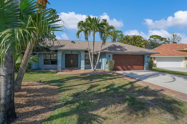 view of front of home with a garage and a front lawn