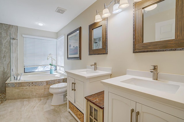 bathroom with vanity, tiled bath, and toilet