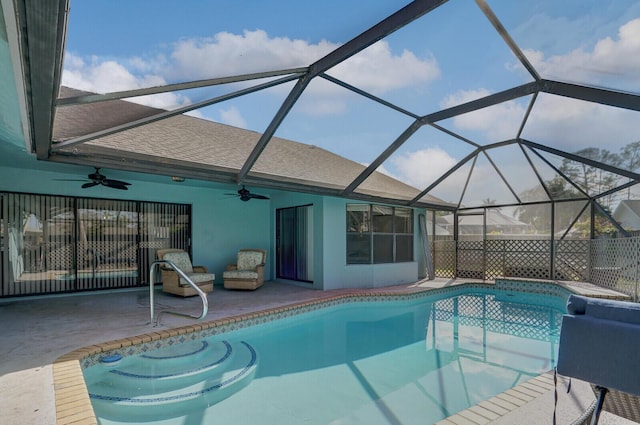 view of swimming pool with a patio, a lanai, and ceiling fan