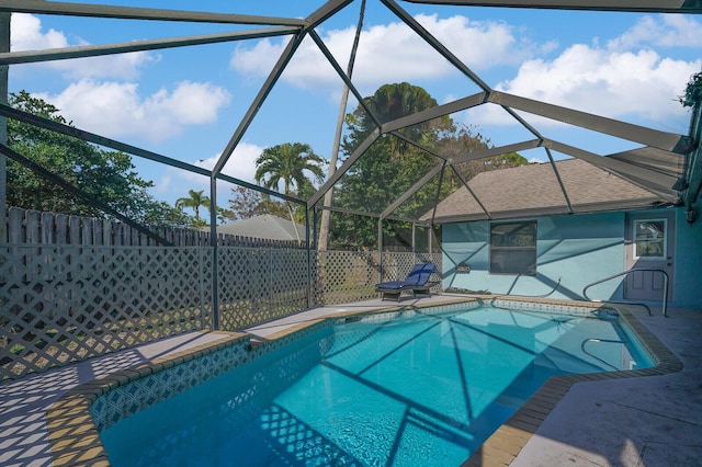 view of swimming pool with a lanai and a patio