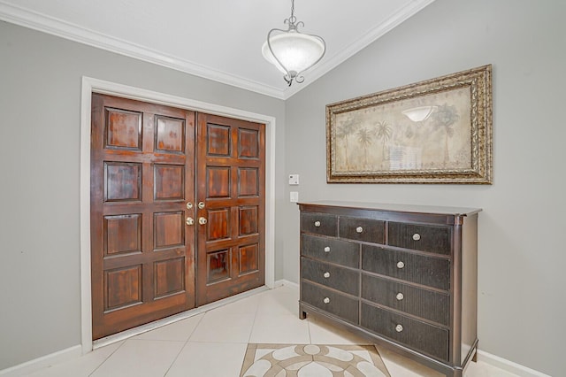 entrance foyer with ornamental molding and light tile patterned floors