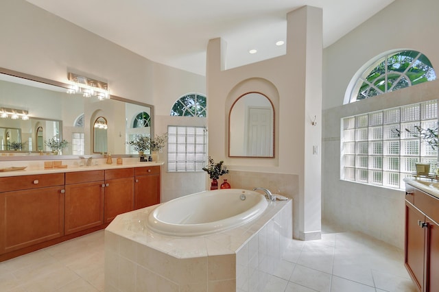 bathroom with tile patterned flooring, vanity, and separate shower and tub