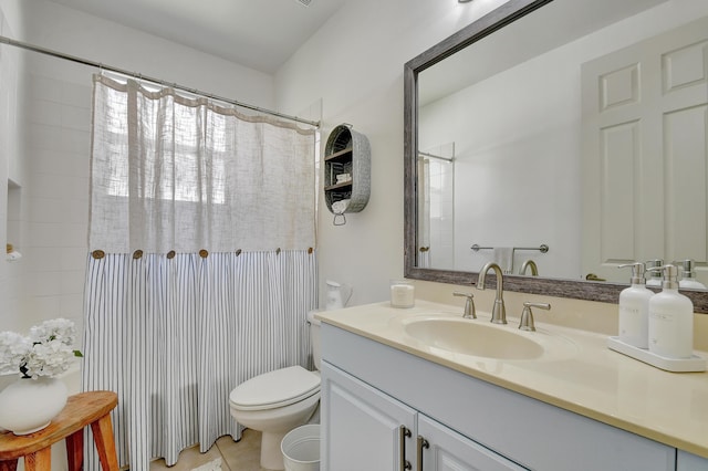 bathroom with tile patterned flooring, vanity, and toilet