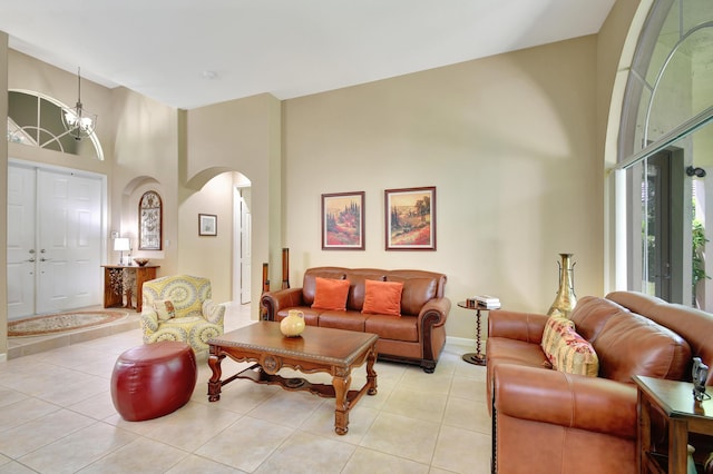 tiled living room with a notable chandelier