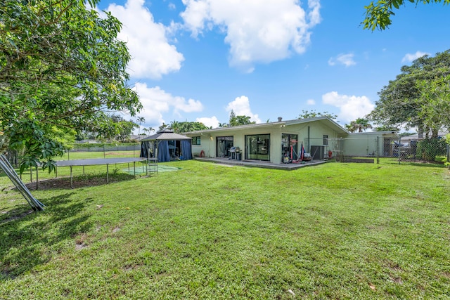 back of property with a gazebo, a yard, and a patio