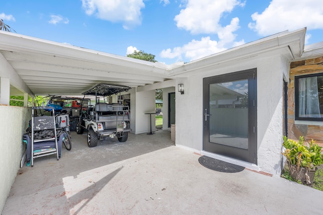 doorway to property with a carport