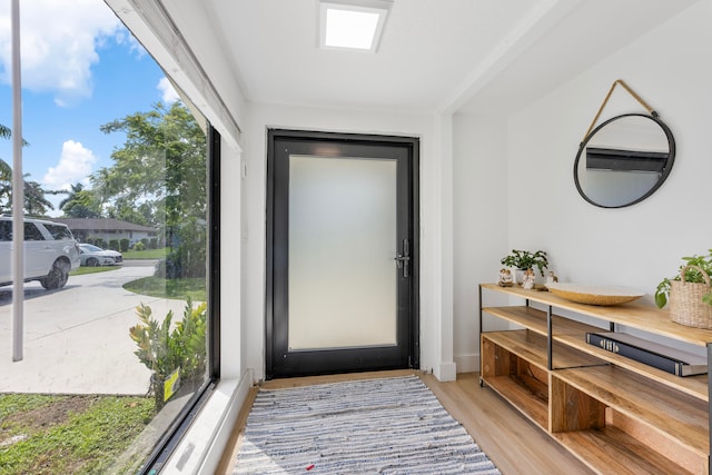 doorway to outside with light wood-type flooring