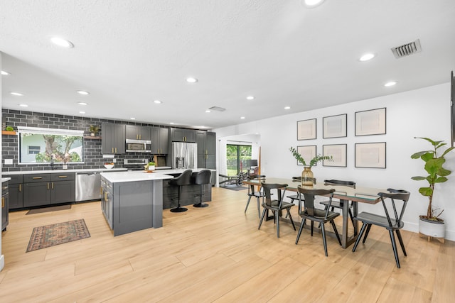 dining room featuring light hardwood / wood-style flooring and sink