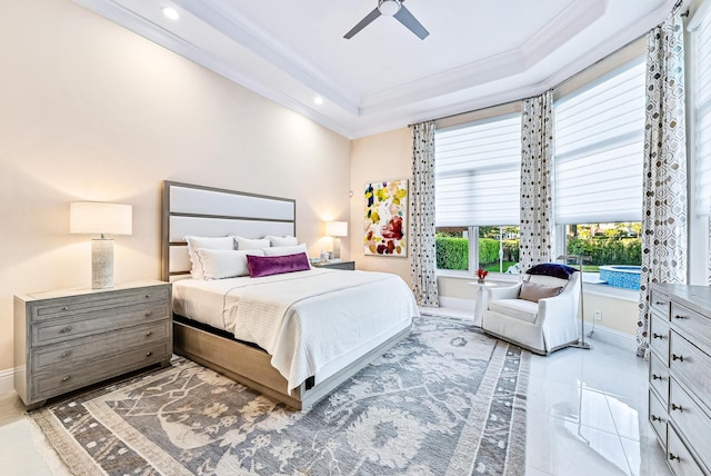 tiled bedroom with ceiling fan, ornamental molding, and a tray ceiling