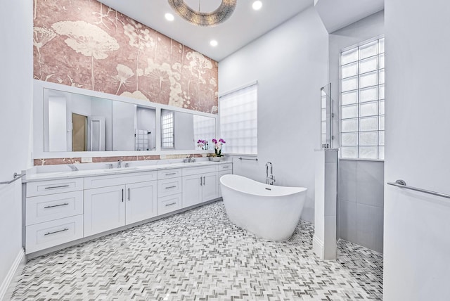 bathroom featuring vanity and a tub to relax in