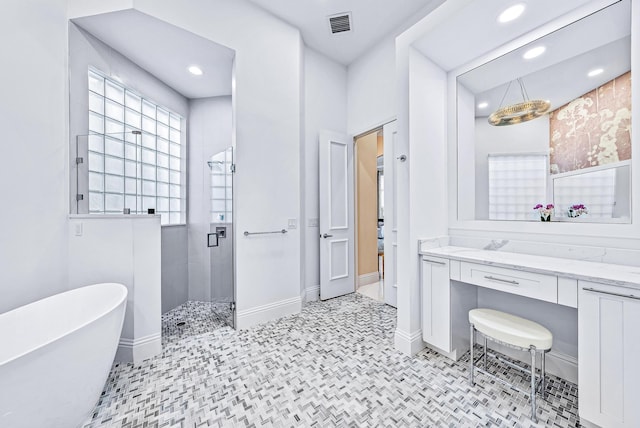 bathroom with vanity and shower with separate bathtub