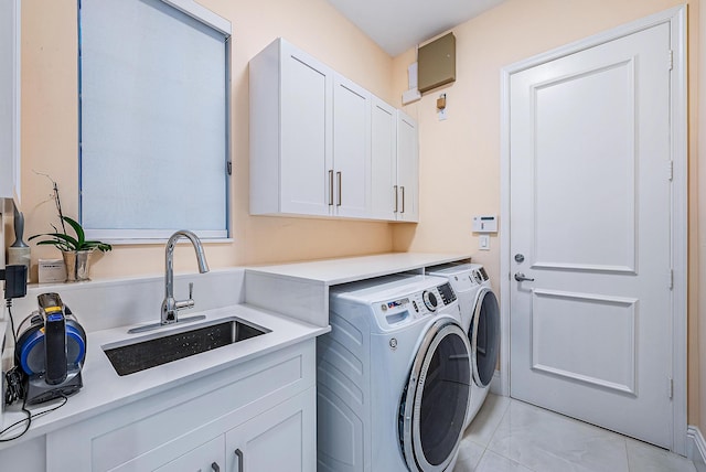 laundry room with separate washer and dryer, sink, and cabinets