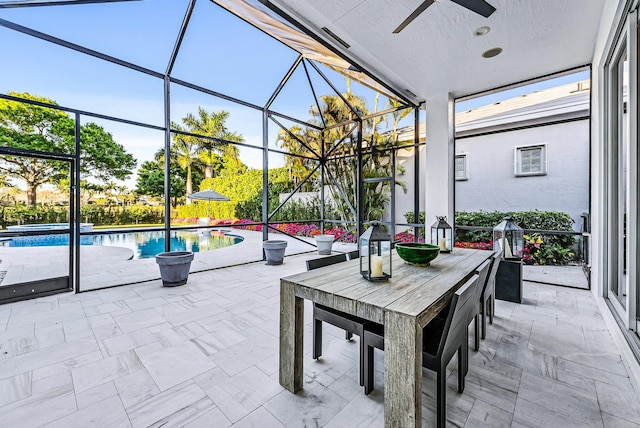 view of patio with ceiling fan and a lanai