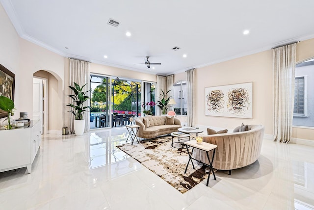 living room with ceiling fan and ornamental molding