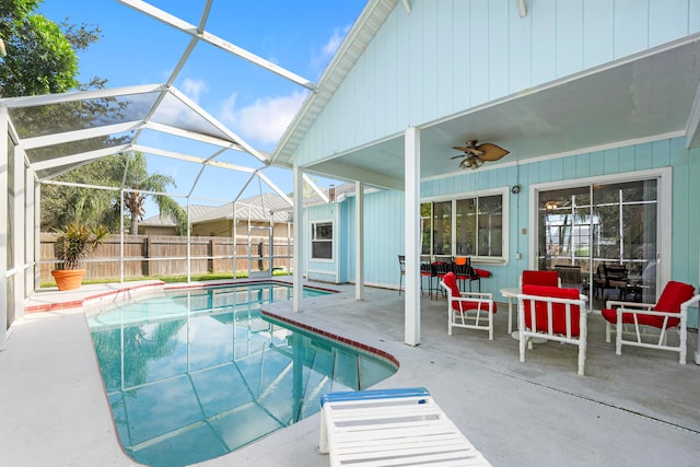 view of pool featuring a patio area, a lanai, and ceiling fan