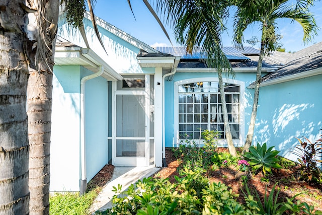 doorway to property with solar panels