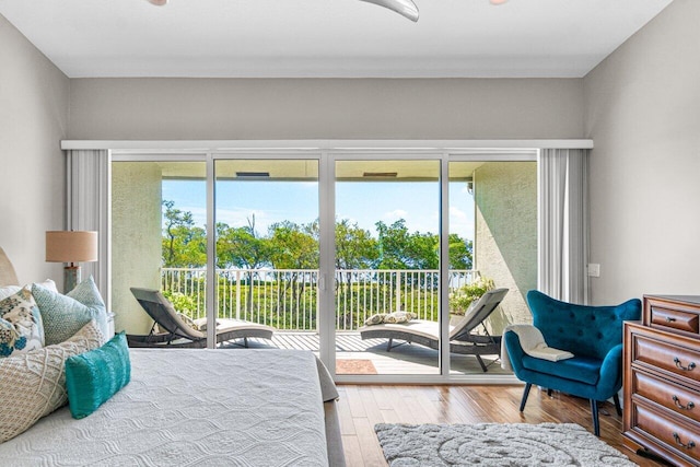 bedroom featuring hardwood / wood-style flooring and access to outside