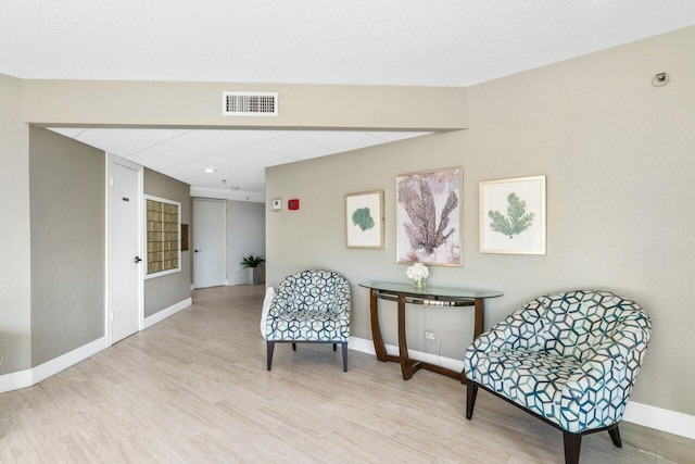 sitting room with light hardwood / wood-style floors