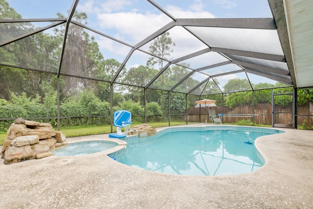 view of swimming pool featuring glass enclosure and a patio area