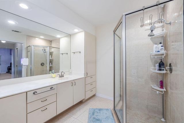 bathroom featuring vanity, tile patterned flooring, and a shower with door