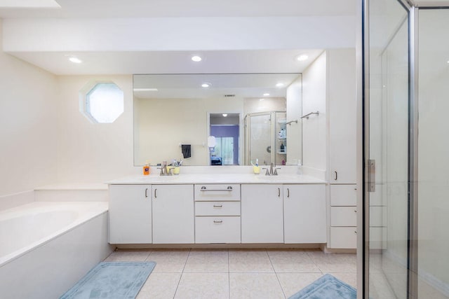 bathroom with independent shower and bath, vanity, and tile patterned floors