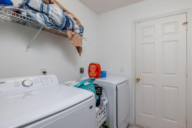 washroom with washing machine and clothes dryer