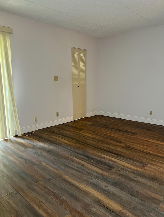 unfurnished room featuring dark hardwood / wood-style floors