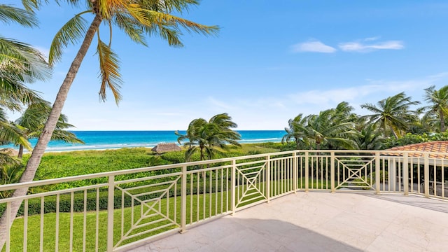 balcony featuring a water view and a view of the beach