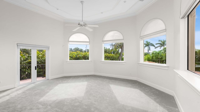 unfurnished sunroom featuring ceiling fan