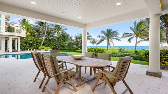 view of pool featuring a patio and a water view