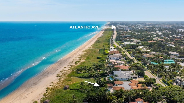 drone / aerial view with a water view and a view of the beach