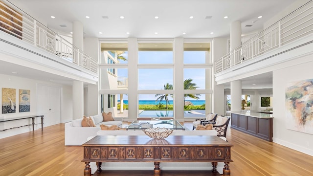 living room featuring a high ceiling and light wood-type flooring