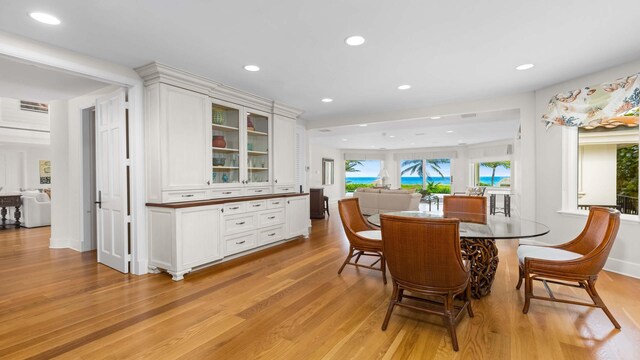 living room featuring light wood-type flooring and a high ceiling