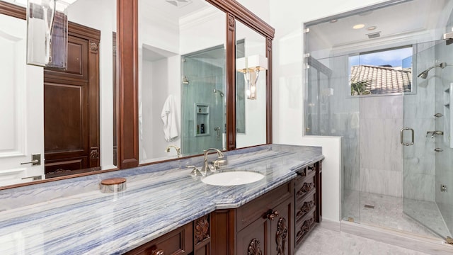 bathroom featuring vanity, an enclosed shower, and ornamental molding