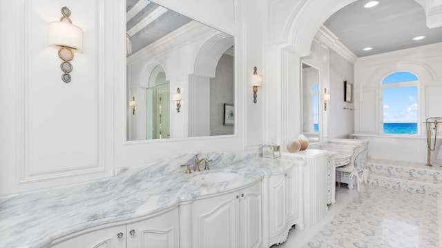 bathroom featuring vanity and ornamental molding