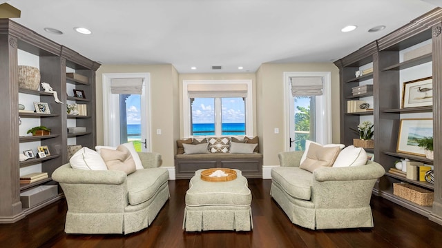 living room with a water view and dark hardwood / wood-style floors