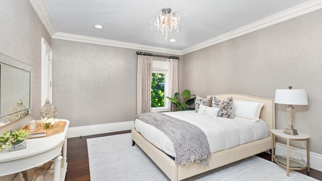 bedroom with hardwood / wood-style floors, ornamental molding, and an inviting chandelier