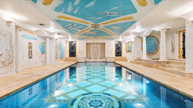 view of swimming pool with decorative columns