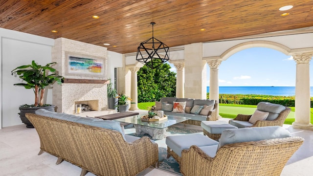 view of patio with outdoor lounge area and a water view