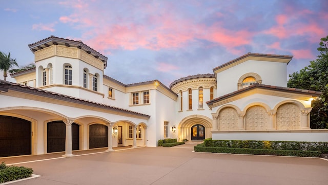 mediterranean / spanish home with french doors and a garage